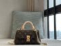 LV Monogram Mini Trunk bag with brown monogram pattern, beige handle and gold-tone chain